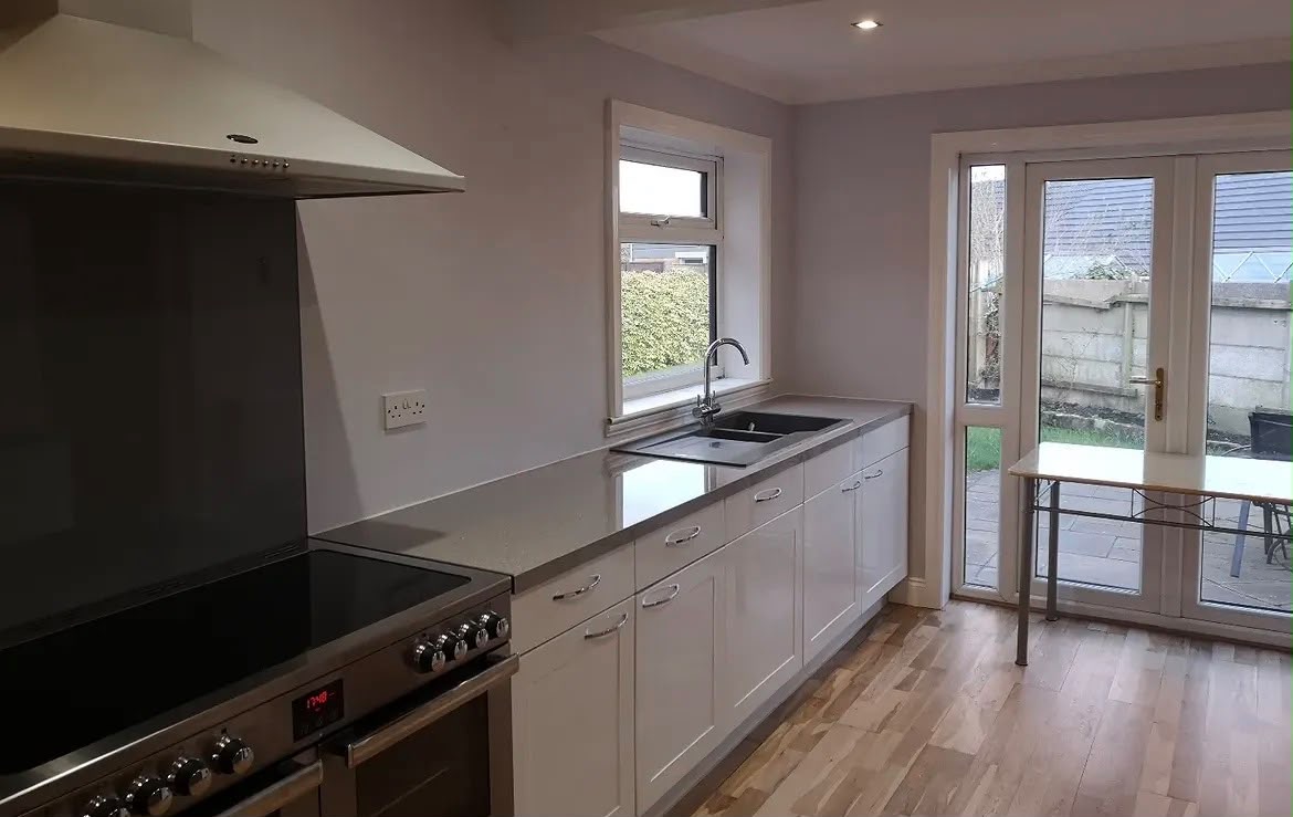 Redecorated kitchen with white units, range cooker and fresh paintwork by English Rose