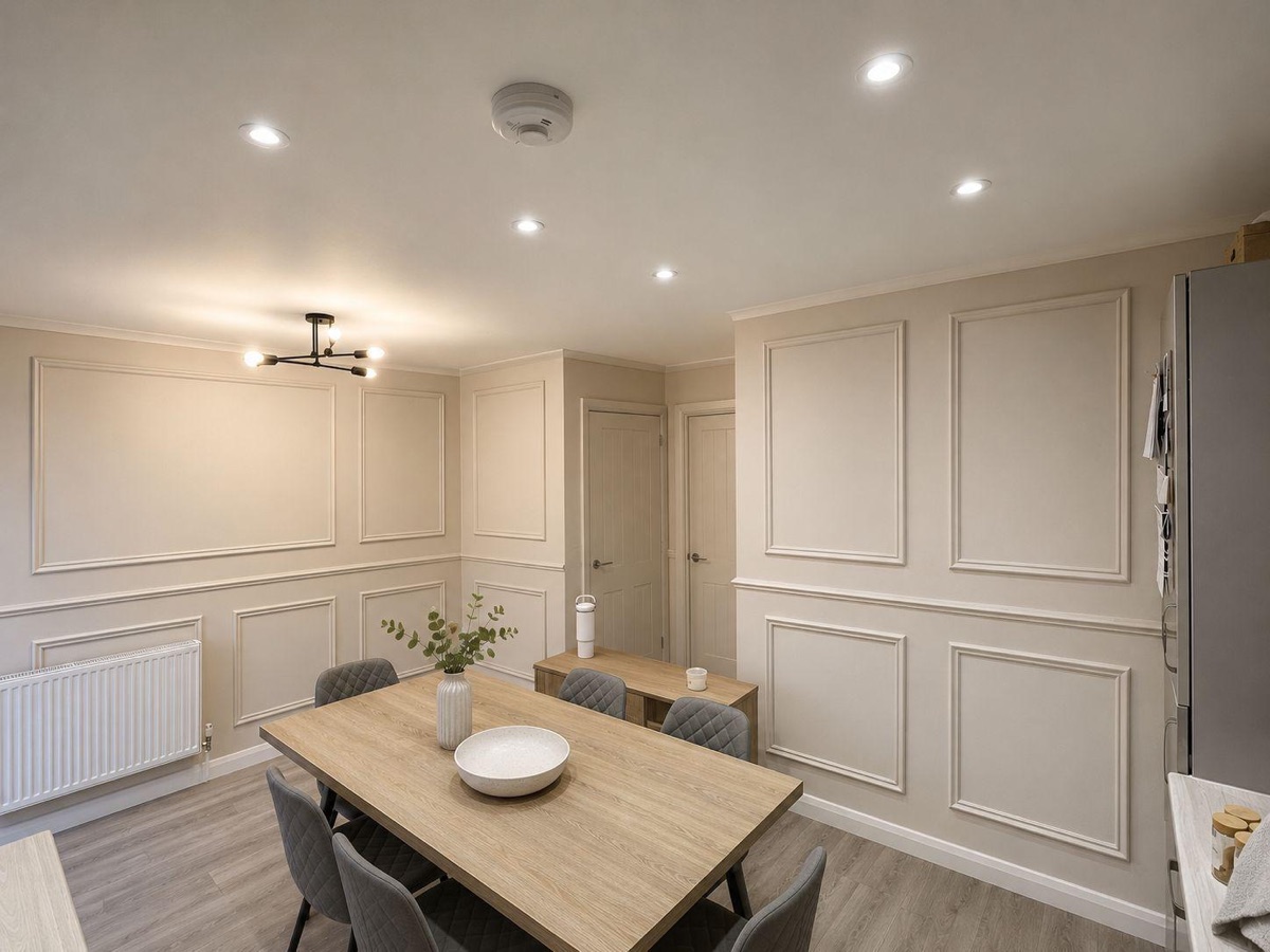 Dining room with cream wall panelling and moulding, decorated by English Rose