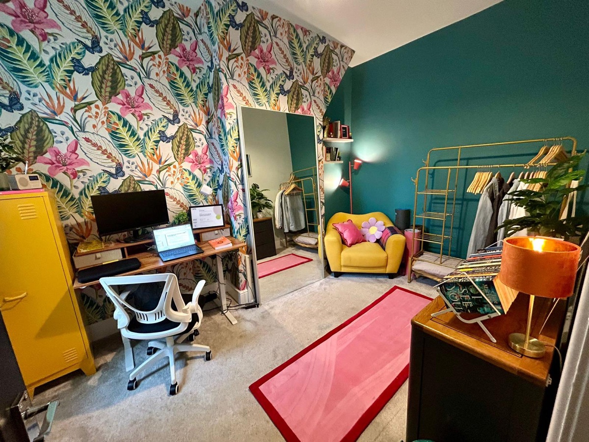 Home office with bold tropical floral wallpaper and teal walls, decorated by English Rose